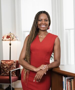 Author headshot of Jallicia Jolly smiling in an office